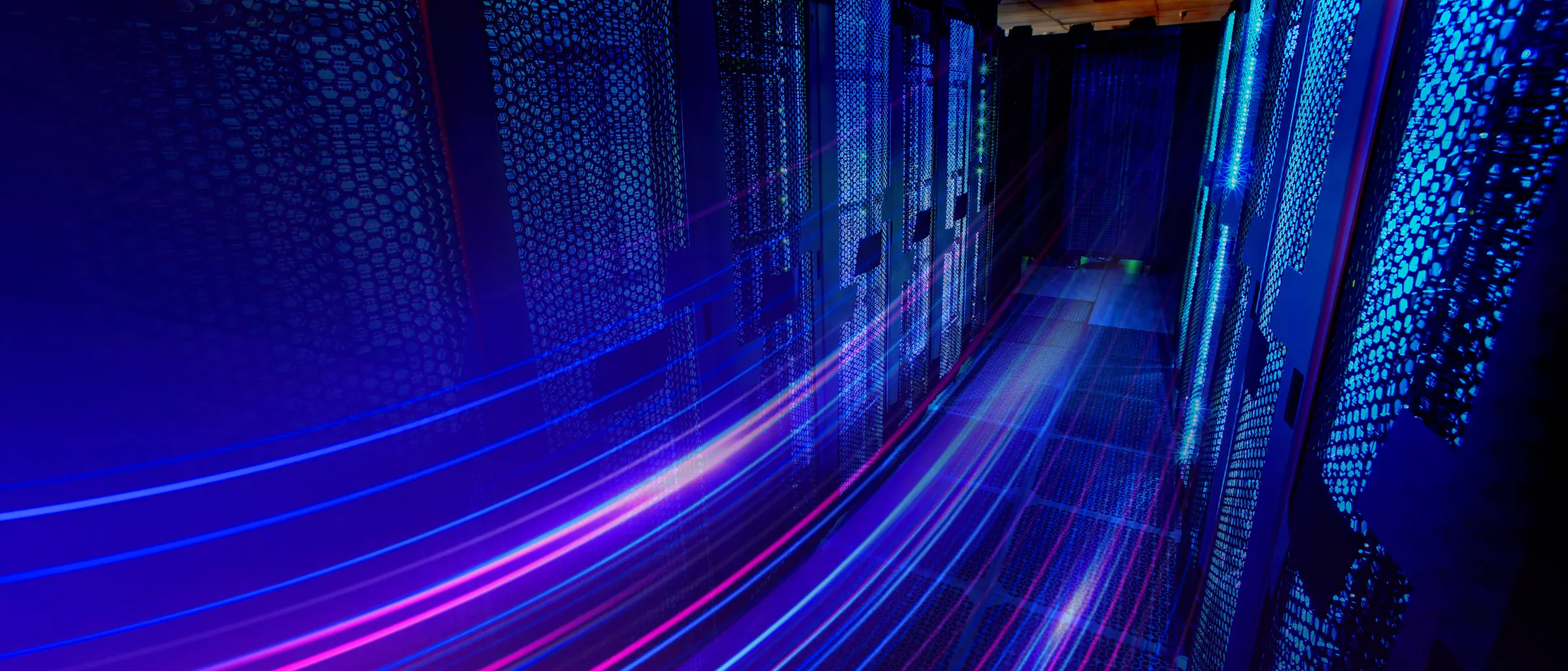 Data centre aisle with light trails running through the racks
